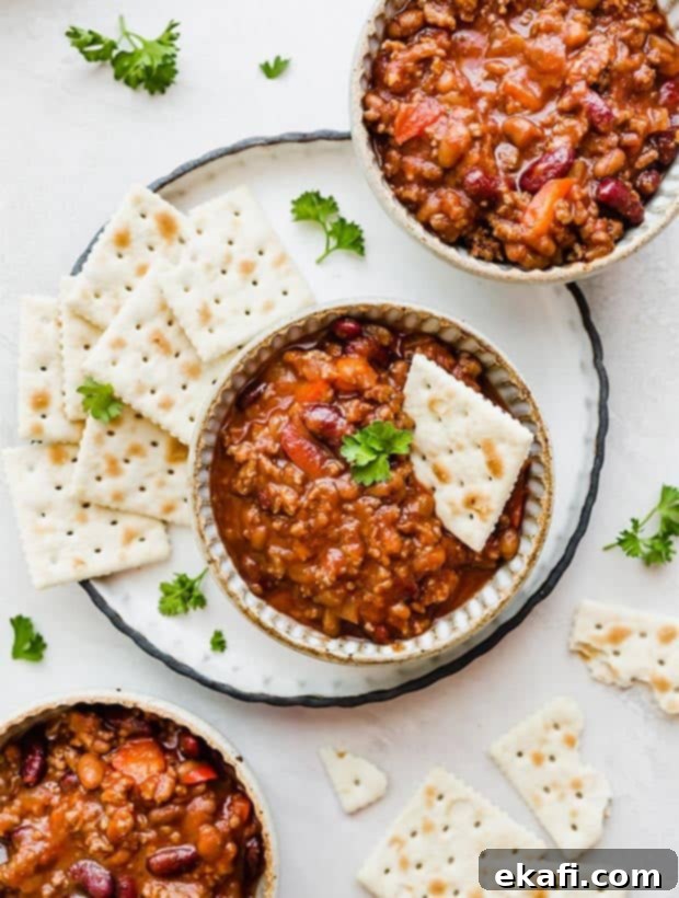 Gridiron Grub 22 Three bowls of sweet and spicy chili with saltine crackers scattered around the bowls.