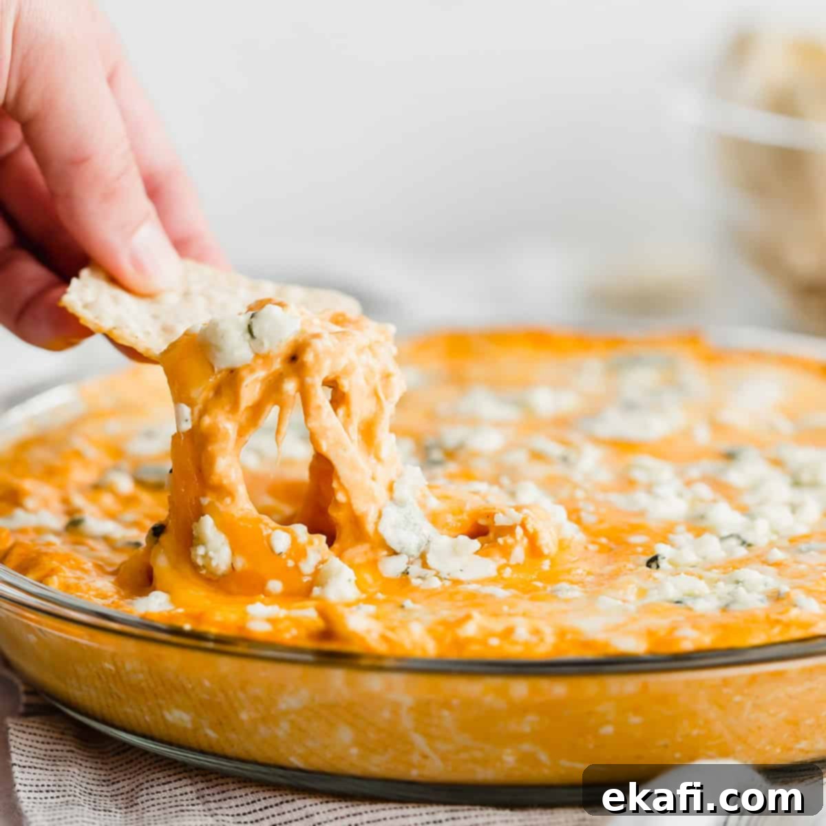 Gridiron Grub 6 A tortilla chip dipping into buffalo chicken dip.