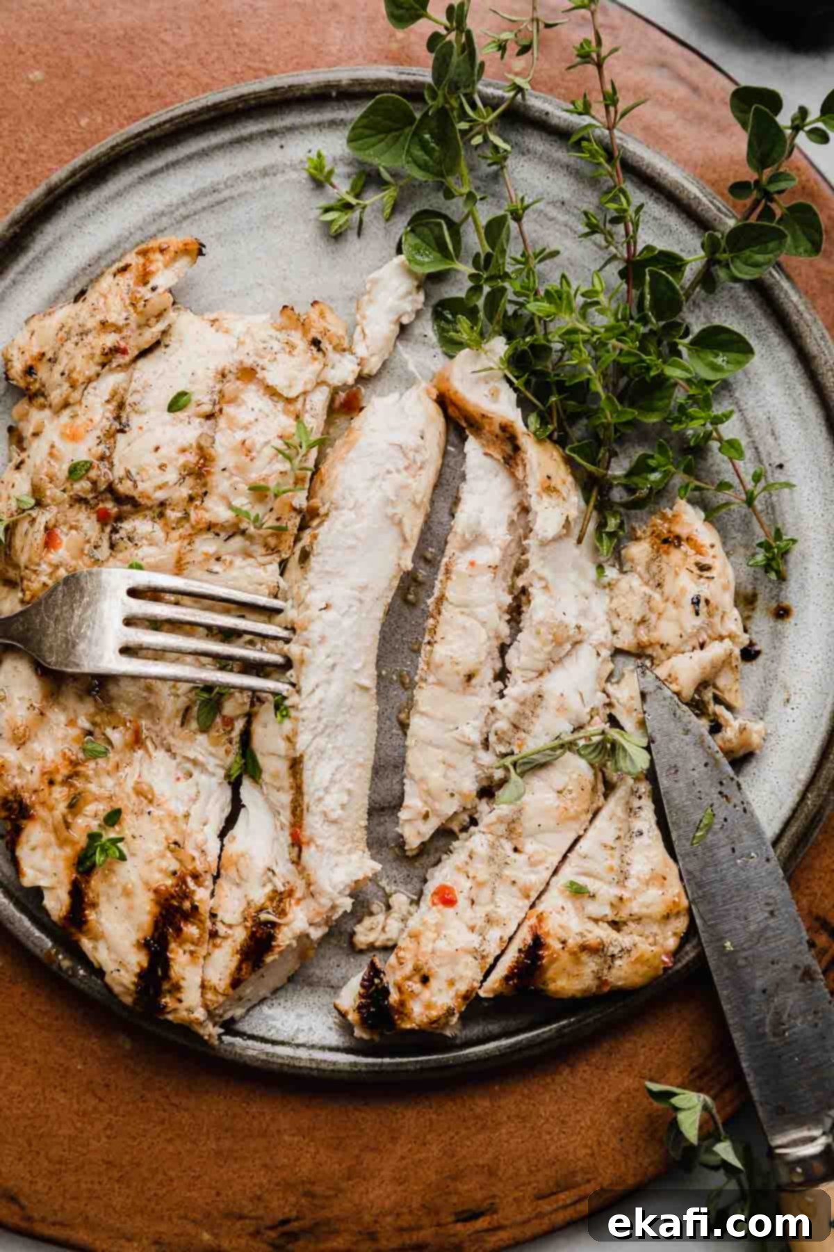 Zesty Italian Grilled Chicken 2 Italian Grilled Chicken sliced into strips, on a gray plate.